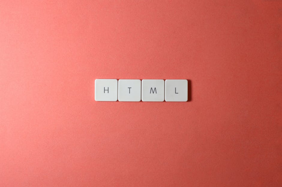 A close-up image featuring four white keyboard keys arranged horizontally on a smooth, pink surface. The keys display the letters 'H', 'T', 'M', and 'L', representing the foundational elements of web